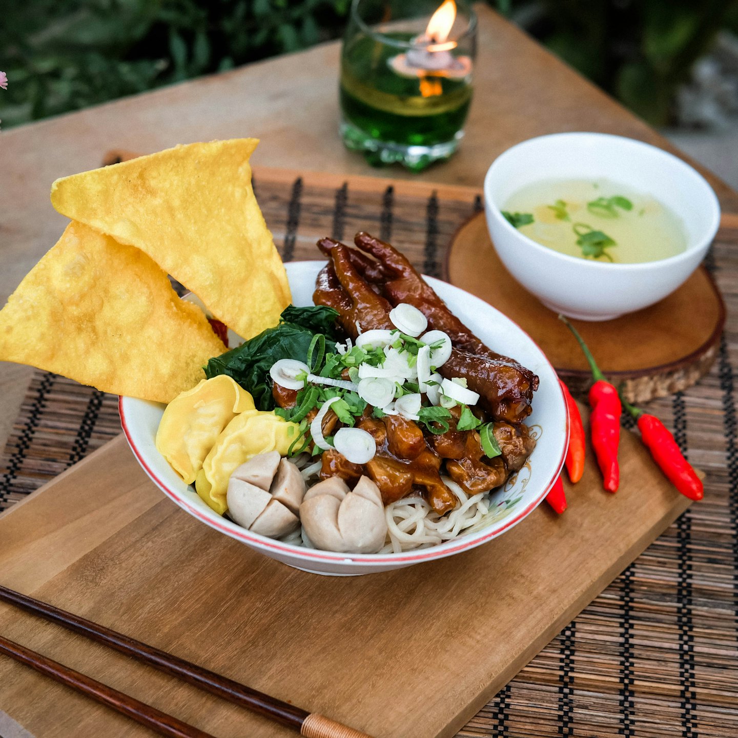 Bowl of Indonesian noodles with chicken feet, meatballs, and dumplings.