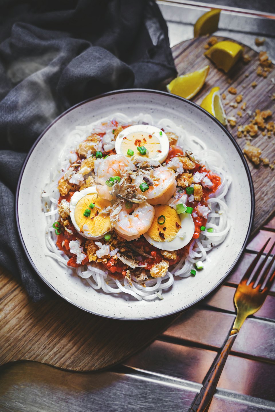 Bowl of pancit palabok noodles with shrimp and egg.
